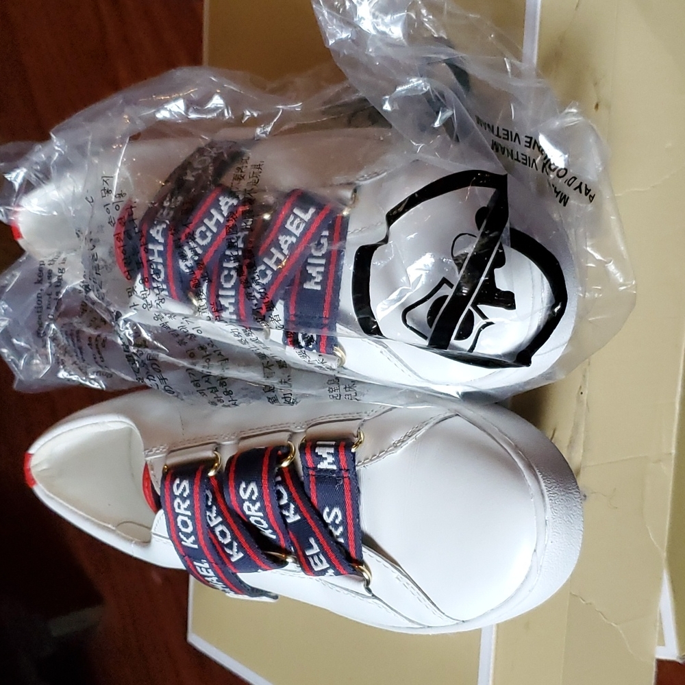 mk sneakers. color  white with logo across  in red n blue.